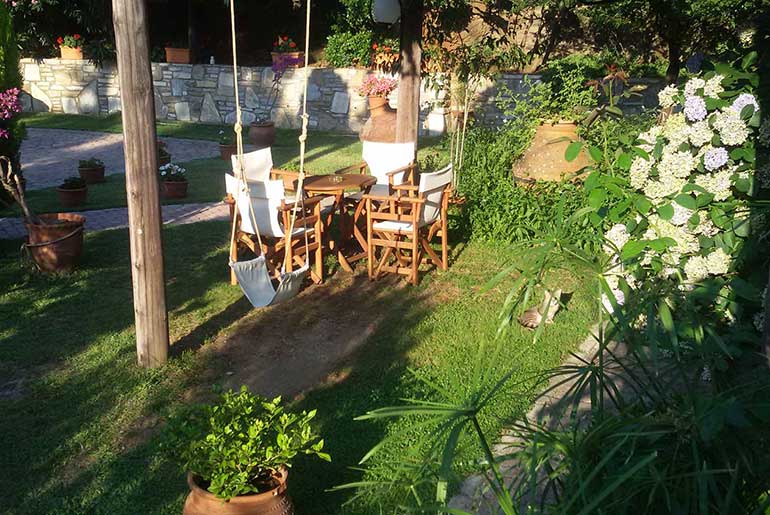 Seating area and swing in the garden of Villa Dimitra